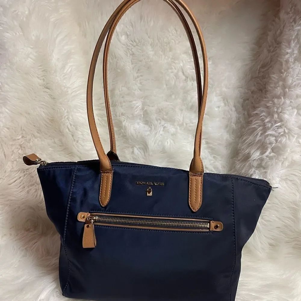 Michael Kors Nylon Navy blue tote with tan straps and trim.gold tone hardwares